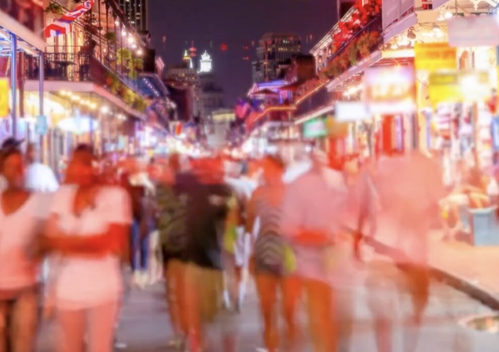 A nighttime photo of Bourbon Street in New Orleans, LA.