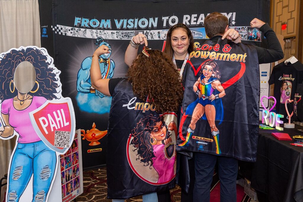 A booth with women wearing t-shirts with the word "Empowerment"