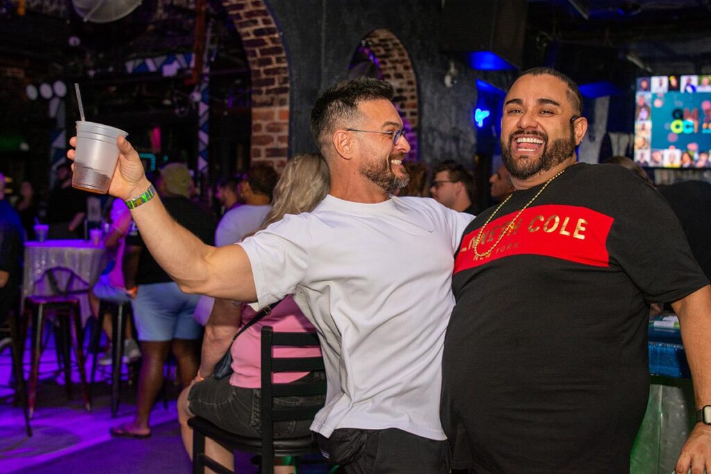 Two guys celebrating with a beer.