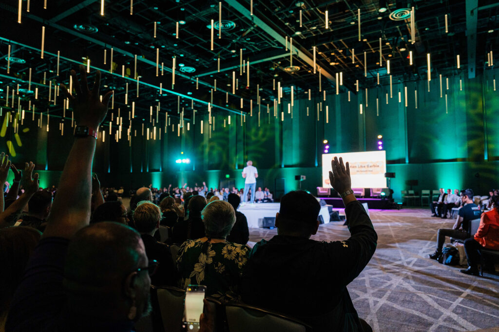 A speaker on stage at the Biomedical H.I.V. Summit