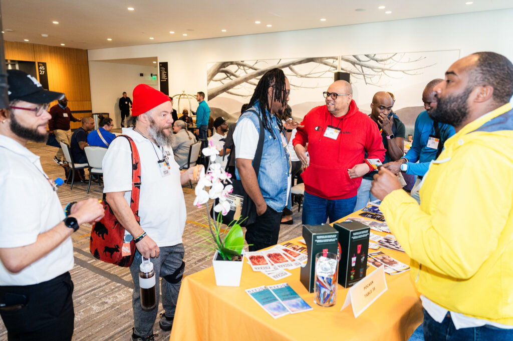 Conference goers at an exhibition booth at Biomedical H.I.V. Summit
