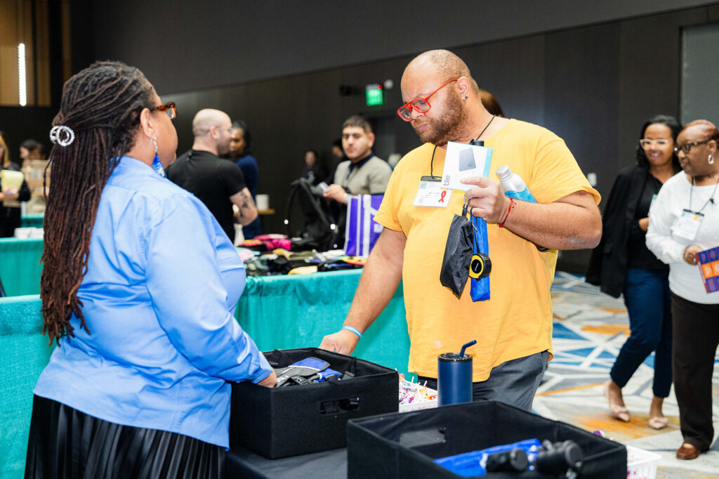 A conference goer interacting with an Exhibitor.
