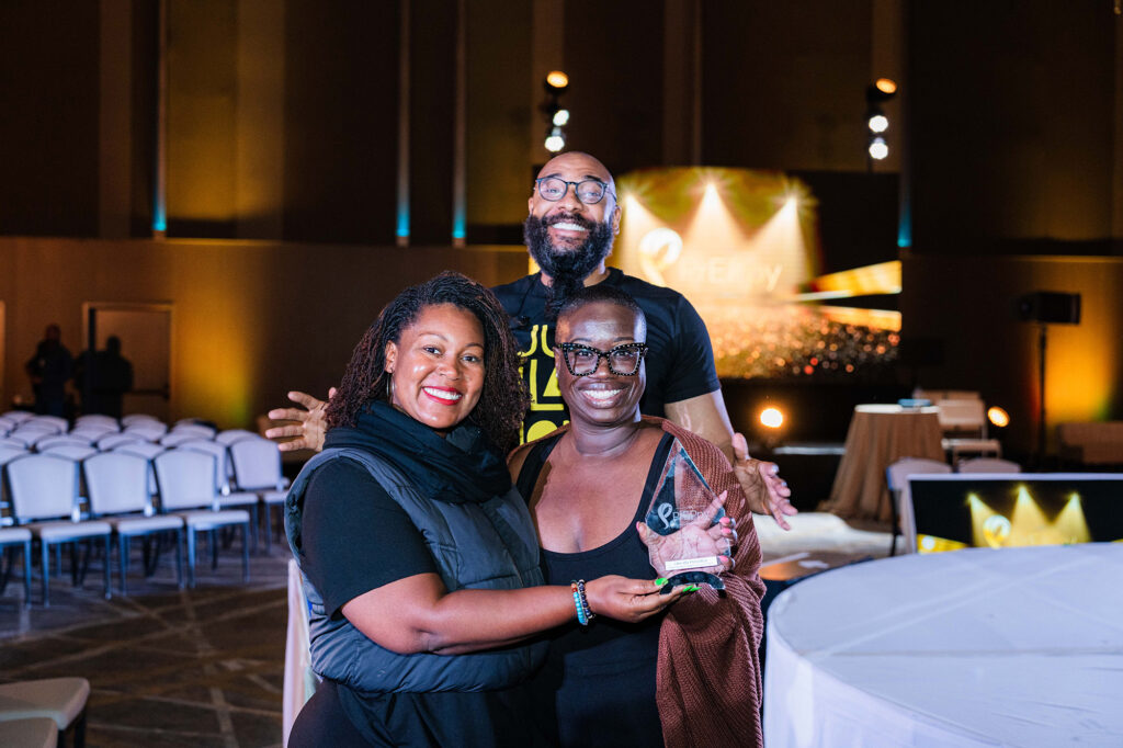 People pose in front of the Summit's conference hall.